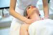 © Bojan - Young woman receiving decollete massage in beauty salon