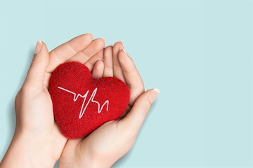 Poster - World Hypertension Day. Adult holds a red heart with a heartbeat chart, a symbol of high blood pressure.