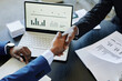 © Seventyfour - Top view close up of two impersonal business men shaking hands across meeting table in office after negotiating deal