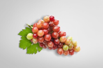 Wall Mural - Red grapes with green leaves on background.