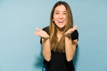 Wall Mural - Happy girl blowing a kiss in a studio and laughing