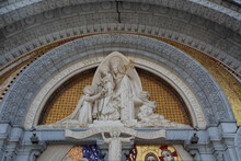 Close Up Of The Statue Of Virgin Mary Above The Front Doors Of Our Lady Of Lourdes Sanctuary In France