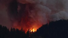 Large Forest Fire Burns The Tree Covered Side Of A Mountain In Oregon