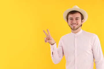 Wall Mural - Concept of people, young man on yellow background