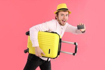 Wall Mural - Concept of travel, young man on pink background