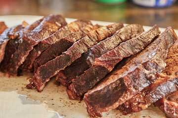 Poster - Sliced pieces of beef, fried with onions in wine sauce, ready to serve on board. French gourmet cuisine