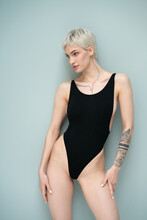 Young Beautiful Woman Posing In Black Bodysuit In Studio