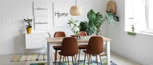 Interior Of Modern Stylish Dining Room With Monstera Plant