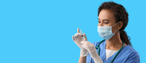 Sticker - African-American nurse with syringe on blue background with space for text