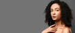 © Pixel-Shot - Portrait of beautiful African-American woman on grey background with space for text