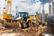 Excavator digs piles. Earthworks for the construction of the foundation. Construction equipment for the device of piles. Preparatory work for grillage.