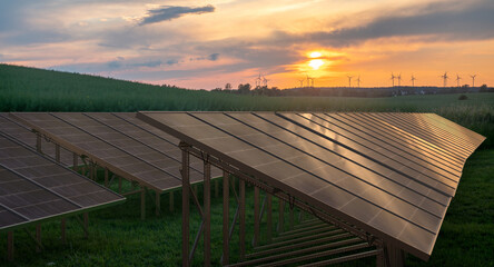 Wall Mural - photovoltaic panels and windmills at sunset