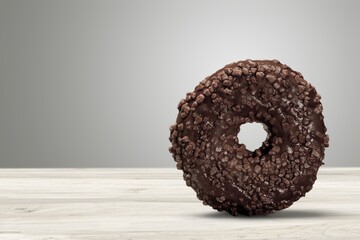 Canvas Print - Tasty sweet chocolate glazed donut with crumbs and creme filled