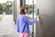 Young Stylish Woman Getting Access To The Building By Attaching Smartphone To Intercom. Concept Of Modern Security Technologies For Access And Smart Home