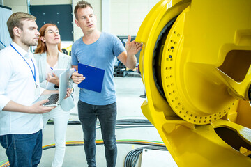 Engineers inspect industrial robot