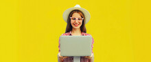Portrait Of Modern Young Woman Working With Laptop On Yellow Background