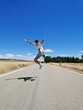© Jose Prieto - teenager celebrating, running, jumping and playing along a lonely road