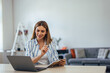 © bnenin - Ambitious businesswoman working alone at the office, holding notebook and pen.