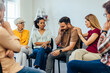 © bnenin - People sitting in a circle, having a group therapy, helping one man who has a hard moment.