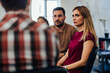 © bnenin - Serious-looking people listen to the male psychologist during the group therapy.