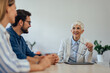 © bnenin - Businesswoman working as an insurance agent, talking to her client, a young couple.