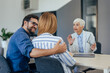 © bnenin - Focused female insurance agent talking to a couple at the office.