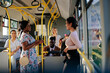 Young women talking in public transportation bus