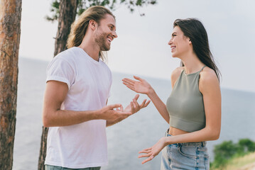 Profile side photo of lovely newlywed couple enjoy their honeymoon near lake river tropical island talking express their love