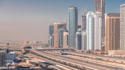 Wall Mural - Dubai Marina skyscrapers and Sheikh Zayed road with metro railway aerial timelapse, United Arab Emirates