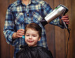 © alexkich - A little boy is trimmed in the hairdresser's