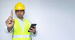 © anut21ng Stock - Male construction worker holding smart phone pointing up with copy space, Technology concept