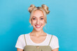 Photo of sweet blond buns hairdo lady wear t-shirt overall isolated on blue color background
