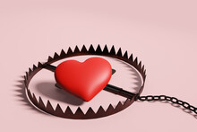 Red Heart Placed In A Rusty Trap On White Background To Illustrate Internet Love Scam Or Online Romantic Swindle.