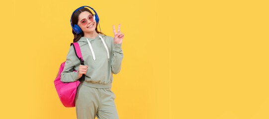 Poster - happy child in headphones carry backpack. back to school. knowledge and education. Casual teen child horizontal poster. Banner header, copy space.