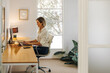© Jacob Lund - Happy young businesswoman working on a laptop in her office
