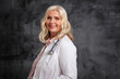 © gzorgz - Senior female doctor studio portrait