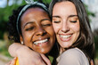 © Xavier Lorenzo - Candid happy multiracial best women friends embracing outdoors - Close up view of two diverse girls hugging each other with closed eyes smiling - Female friendship