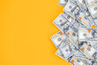© ALEXSTUDIO - Top view of bundle of 100 dollar bill on yellow background. Business concept with copy space