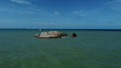 Wall Mural - Seascape view of the ocean and little island rock with blue sky