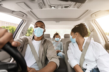 Wall Mural - Black Family Wearing Surgical Face Masks Sitting In New Automobile