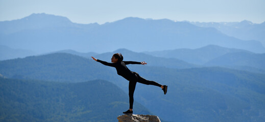 woman practicing yoga in spectacular landscape