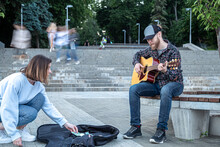 Male Street Musician Plays The Acoustic Guitar.