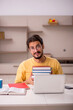 © Elnur - Young male student preparing for exams at home