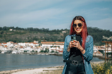 Wall Mural - pretty redhead girl with mobile phone in the street.