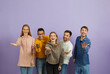 © Studio Romantic - Diverse group of happy cheerful young multiethnic people standing together, looking at the camera, smiling, extending their hands and doing an inviting gesture, telling you 'Come here and join us'