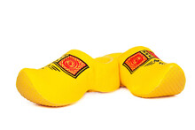 Pair Of Traditional Dutch Yellow Wooden Shoes Over White Background. Popular Souvenirs. Traditions Of Holland	