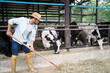 © Kawee - Attractive Caucasian male dairy farmer working alone outdoors in farm.