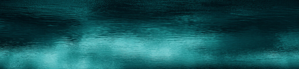 Wall Mural - Blue green water surface. Night. Small waves. Ripples. Reflection of light. Dark teal water background with space for design. Web banner. Wide. Panoramic.