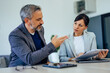 © bnenin - Mature businessman talking to a female employer at the office.