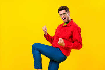 Wall Mural - Photo of hooray young brunet guy yell wear red shirt eyewear isolated on yellow color background